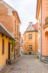 Fototapeta na wymiar Narrow cobbled ancient street with picturesque colorful houses, Medieval old town of Tabor, Czech Republic
