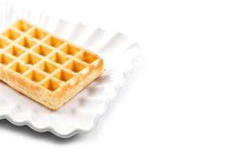 Belgium waffer on white ceramic plate isolated on white background.