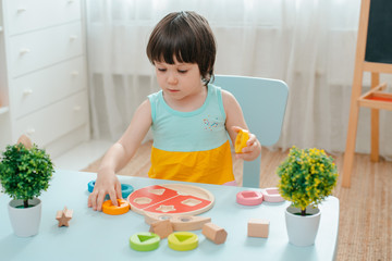 little girl collects wooden multi-colored sorter Safe natural wooden kids toys