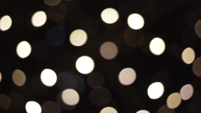 Beautiful bokeh in the night. White bokeh of faity lights
