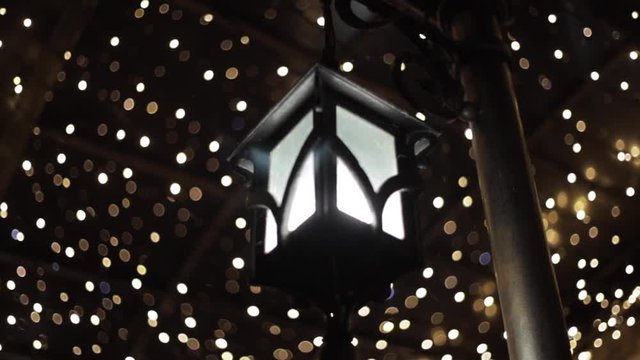 Beautiful bokeh in the night. White bokeh of faity lights