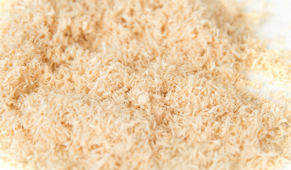 Wood dust from electric saw on white