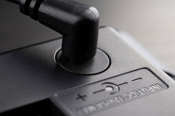 Inserted black 12 volt adapter plug.