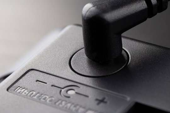 Inserted black 12 volt adapter plug.