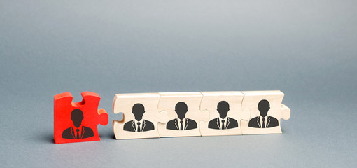 Wooden puzzles with the image of workers. The concept of personnel management in the company....