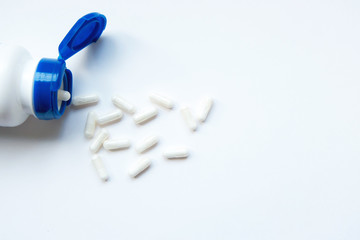 Pills bottles on the white background with pills