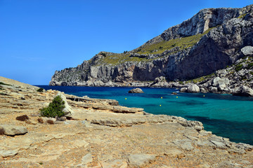 Sea bay with turquoise water, beach and mountains, Cala Figuera on Cap Formentor