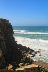 Fototapeta na wymiar Brave sea and cliffs of the coast of Azenhas do Mar in Portugal