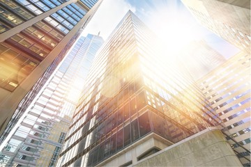 Fototapeta na wymiar Modern office glass buildings over sky background