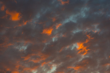 Landscape with dramatic light - beautiful golden sunset with saturated sky and clouds.
