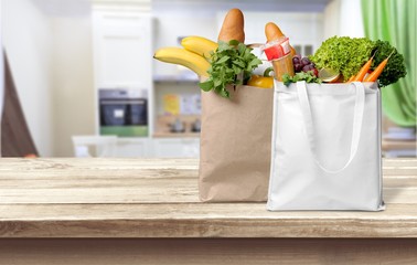 Shopping bags with groceries isolated on white background