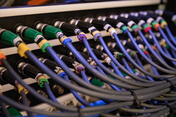 bunch of bnc sdi hd video signal connection on patch panel and switcher coaxial cabling in rack - obrazy, fototapety, plakaty