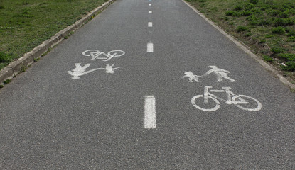 Bicycle and pedestrians road sign on asphalt.