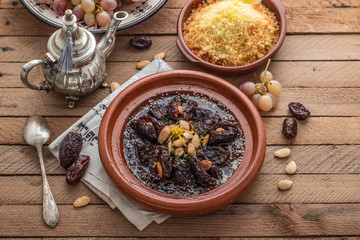 Fototapeta na wymiar Slow cooked beef with dates, raisins and almonds - moroccan tajine
