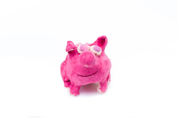 Pink pig made of clay. Sculpting pigs from ceramics. Children's handicraft.