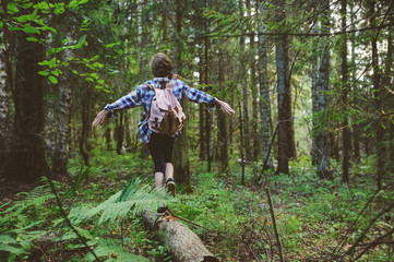 happy kid girl exploring summer forest, traveling on vacation. Teaching kids to love nature. Earth...