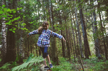 happy kid girl exploring summer forest, traveling on vacation. Teaching kids to love nature. Earth day concept.