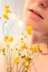 Obraz na płótnie Canvas Girl with yellow flowers