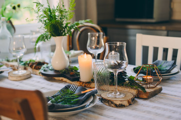 summer country house with festive table decorated for dinner. Cozy place with candles in rustic natural style