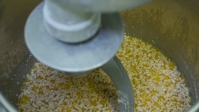 several scoops of flour added to large mixing bowl slow motion. Scoops of flour added to marge mixing bowl.