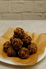 Energy balls - healthy delicious snack rich with fibers and protein. Recipe with oats, walnuts, dates and raisins. Image with copy space, selective focus