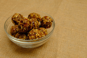 Energy balls - healthy snack rich with fibers and protein. Recipe with oats, walnuts, dates and raisins. Image with copy space,selective focus