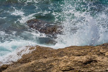Obraz premium Waves breaking on a stony beach in Murter, Croatia, Dalmatia