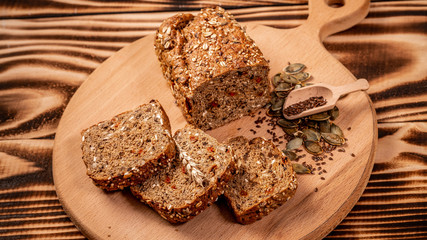 Sliced rye bread on cutting board. Whole grain rye bread with seeds. Ketogenic low carbs diet