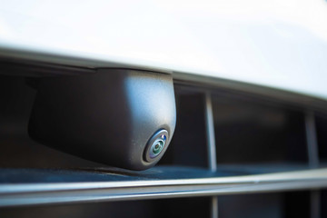 Closeup. Front view camera in the front bumper of the car. Circular 360 degrees surround view system.  Front grill. Parking and offroad assist options of premium SUV