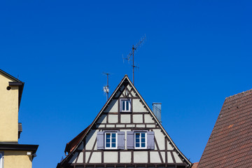 historical house facades and rooftops on blue sky