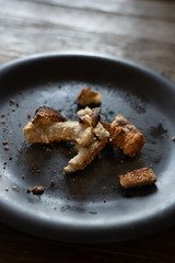 bits of toasted bread crumbs after a meal