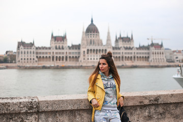 Fototapeta na wymiar girl on Budapest building background 
