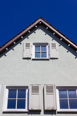 historical house facades and rooftops on blue sky