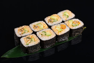 Delicious mussel sushi roll set on banana leaf