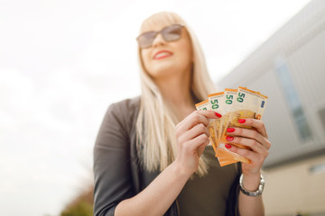 Beautiful woman with euro money cash.