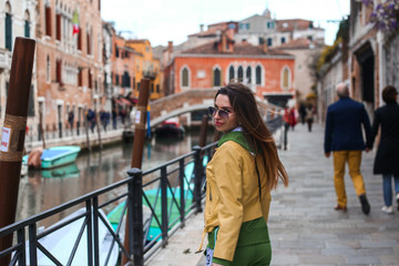 Fototapeta na wymiar girl on Venice stress with Canal and city view 