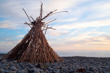 Bamboo Teepee on rocky beach