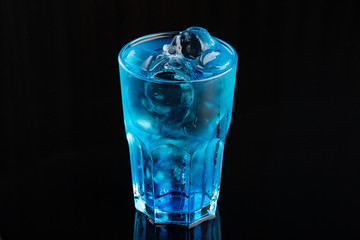 the blue coctail drink with ice cubs