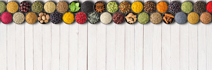 Seasonings and herbs for delicious food. Spices on white table background with empty space © dmitr1ch