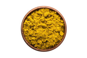 curry powder spice in wooden bowl, isolated on white background. Seasoning top view