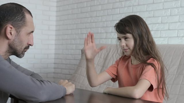 Competition on the hands. Father and daughter are fighting in their arms.