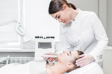 Woman gets native electro stimulating lifting skin therapy at Spa salon