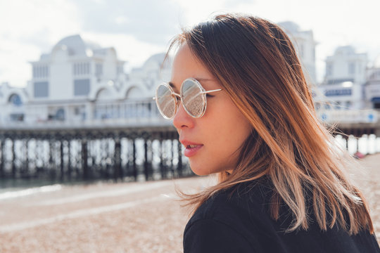 Asian woman wearing sunglasses on the beach