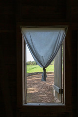 Tied curtain in window of vintage home