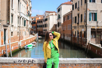 Fototapeta na wymiar girl on Venice street with canal background. and streets 