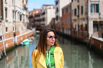 Fototapeta na wymiar girl on Venice street with canal background. and streets 