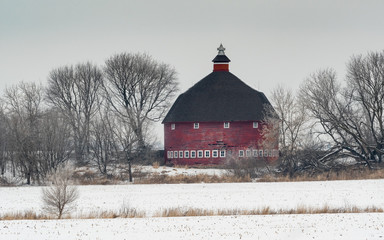 A red round barn among the trees © David Halgrimson