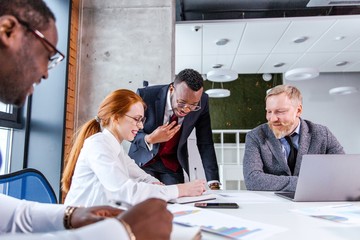 Business people of different ethnicity at a business meeting in a modern office at the table...