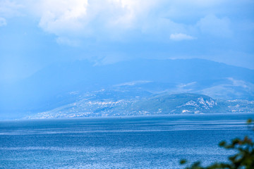 lake in the mountains with blue clouds and high rocks 