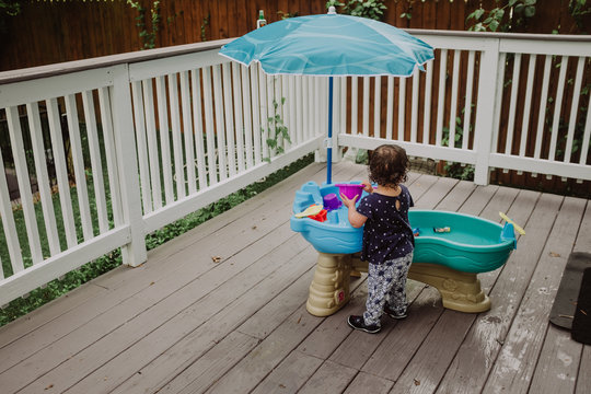 Child playing with water table